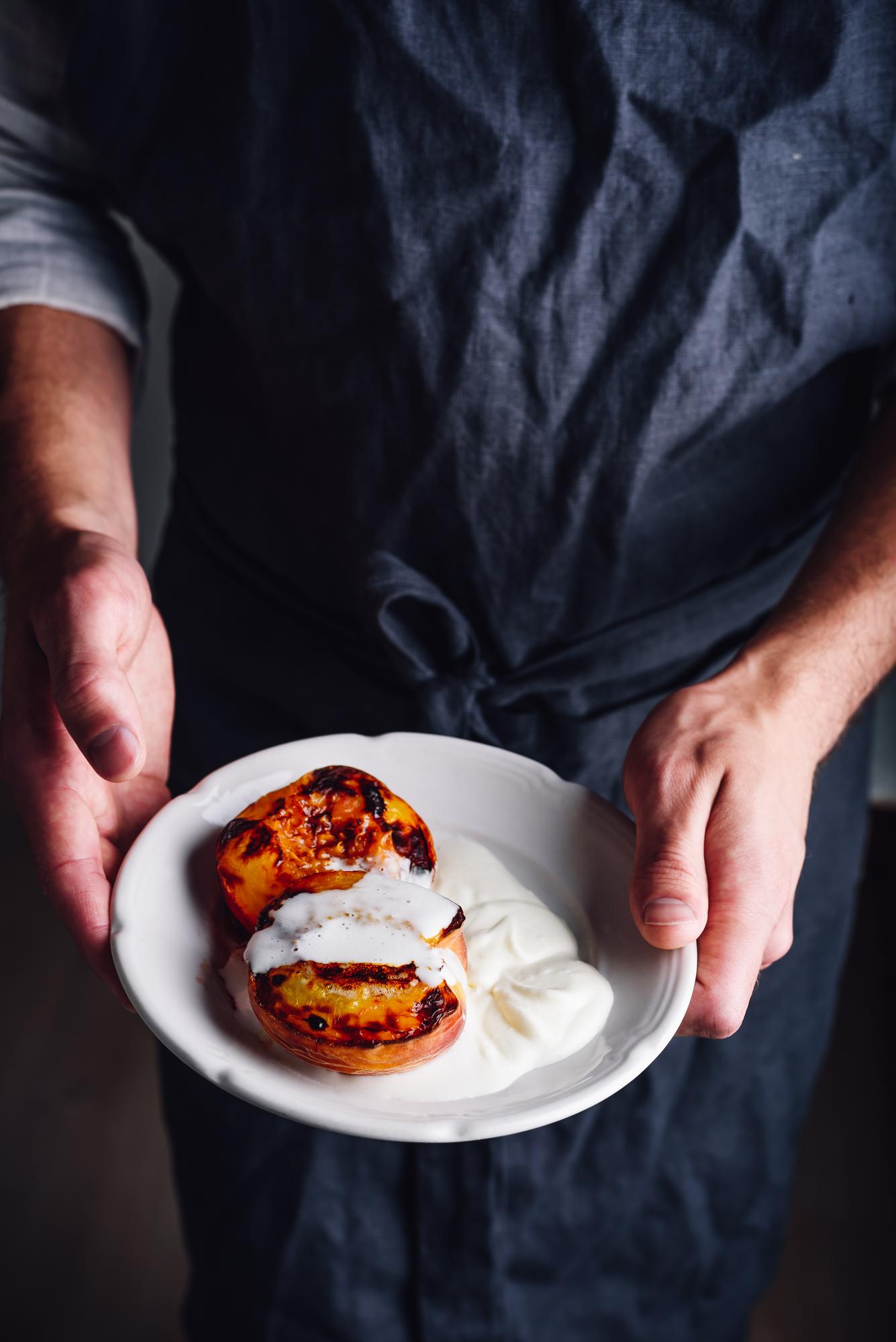 artisan chef plating a dish in warm kitchen